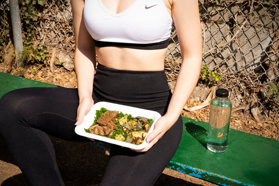 woman wearing white and black Nike sports bra. science-backed sports nutrition