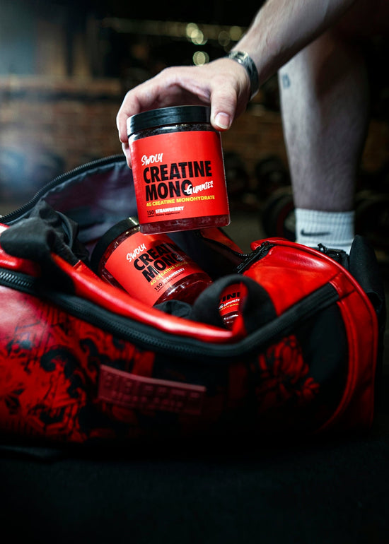 a man is holding a cup of coffee in a duffel bag. reds superfood powder benefits