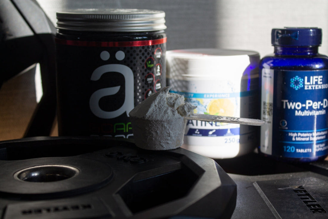 a table topped with bottles of vitamins and pills. vegan protein powder for lean muscle recovery