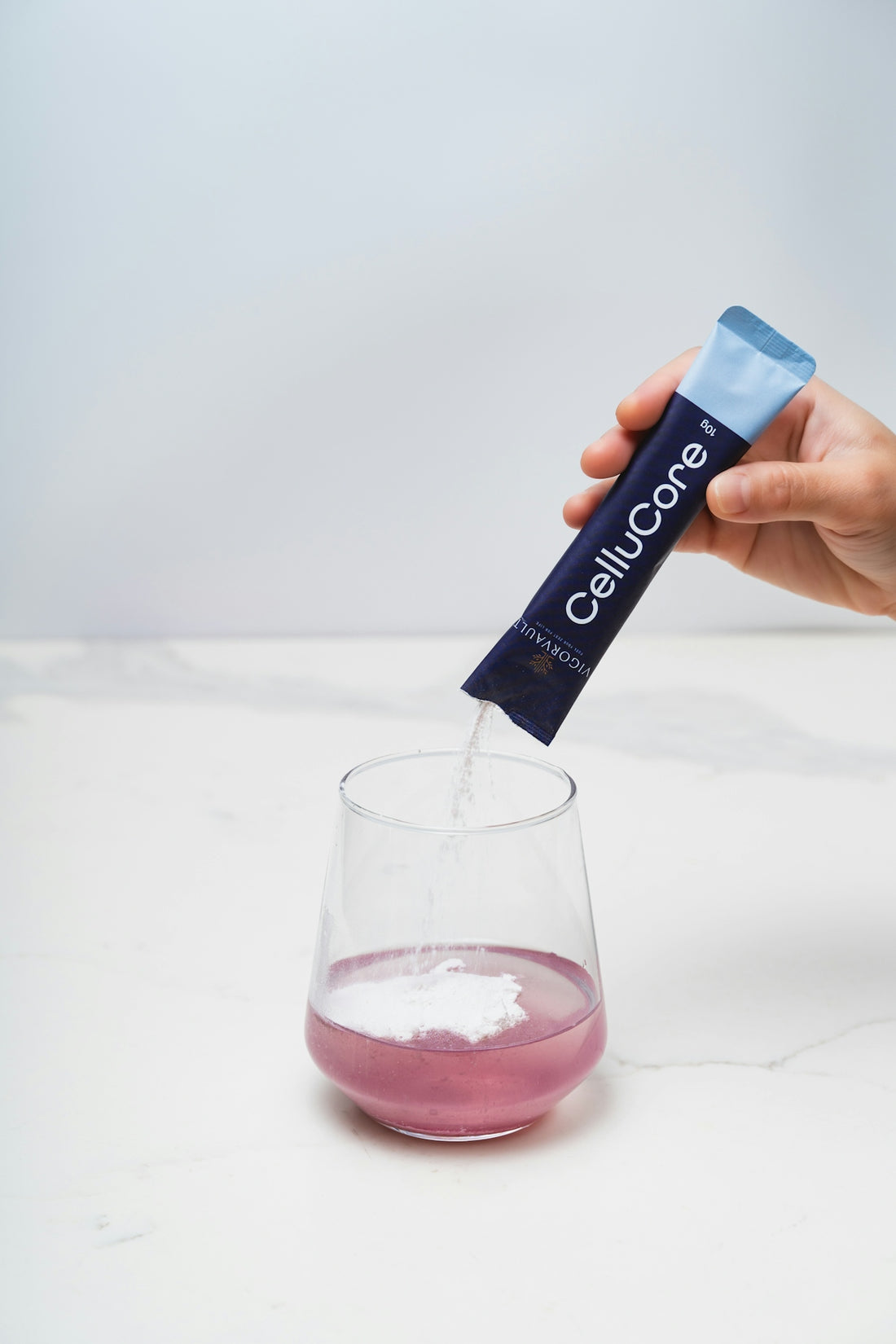 Powder is poured from a cellucore stick into a glass.