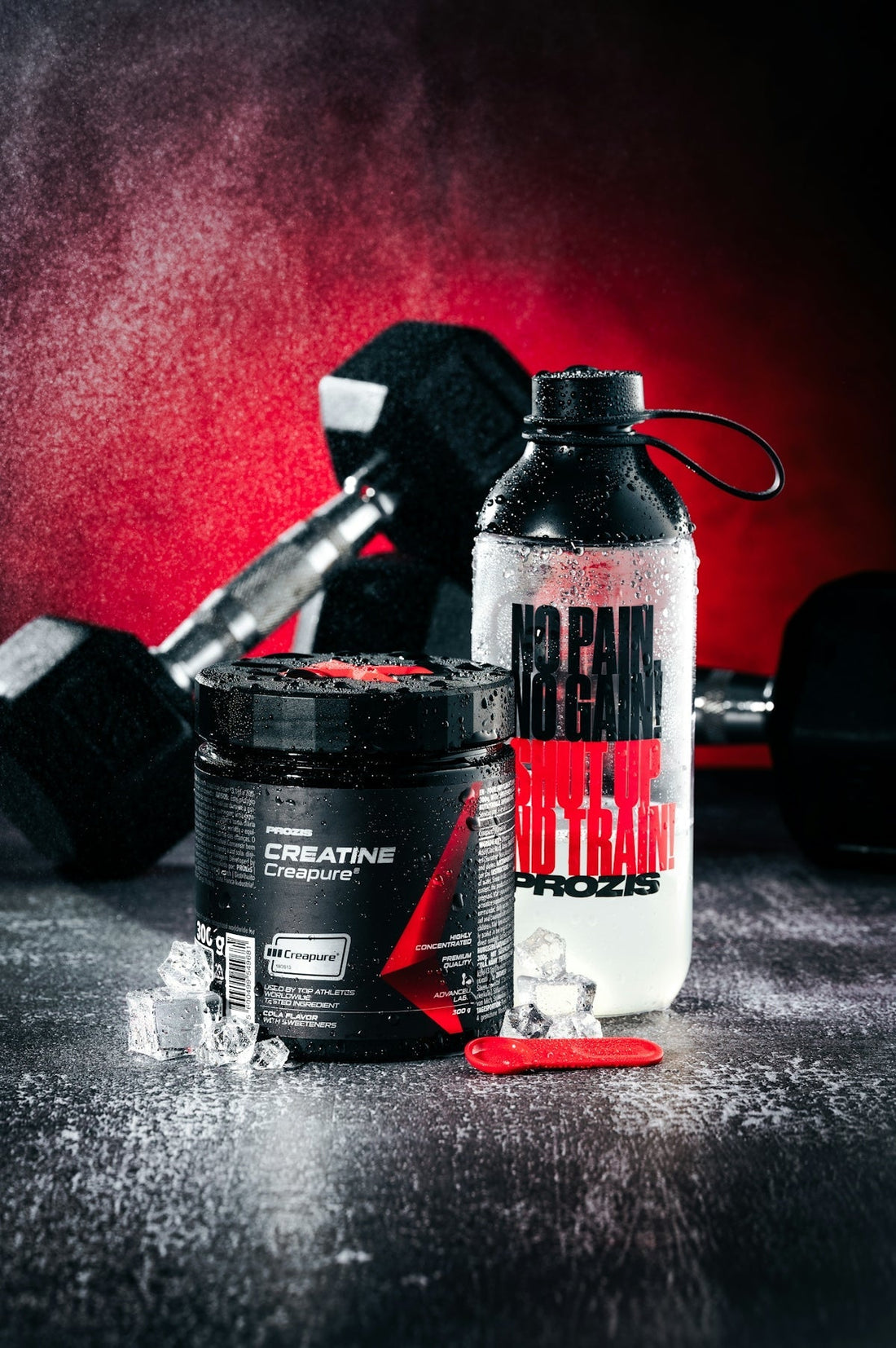 Creatine supplement, water bottle, and dumbbells on wet surface. best pre-workout supplement for intense workouts