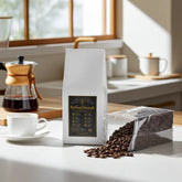 BigSouthStrength coffee beans bag with fresh roasted beans, coffee maker, and cup on kitchen counter