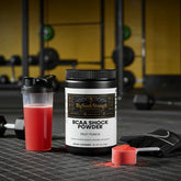 BCAA Shock Powder in Fruit Punch flavor with shaker and scoop, ideal for muscle recovery and strength training