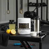 Lemonade hydration powder with shaker, lemons, and gym gear for fitness recovery