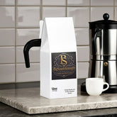 Vitality Mushroom Coffee Medium Roast bag on kitchen counter with espresso maker
