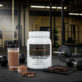 Chocolate whey protein isolate with shaker, dumbbells, and chocolate pieces in gym setting