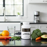 Complete Multivitamin capsules with fresh fruits, veggies, and water on kitchen counter for daily wellness