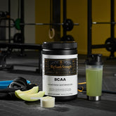 BCAA Honeydew Watermelon supplement with gym gear and mixed drink for muscle recovery