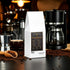 BigSouthStrength Deep Roast Coffee bag with coffee beans, brewer, and steaming cup