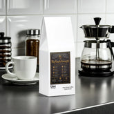 BigSouthStrength Deep Roast Coffee bag on kitchen counter with coffee maker and cup