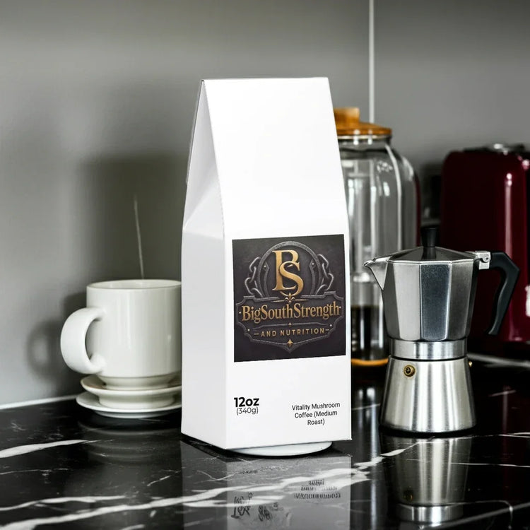 Vitality Mushroom Coffee Medium Roast bag on marble counter with espresso maker and mug