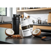 Fat Burner with MCT supplement bottles, coconut halves, cinnamon sticks, and shaker on kitchen counter