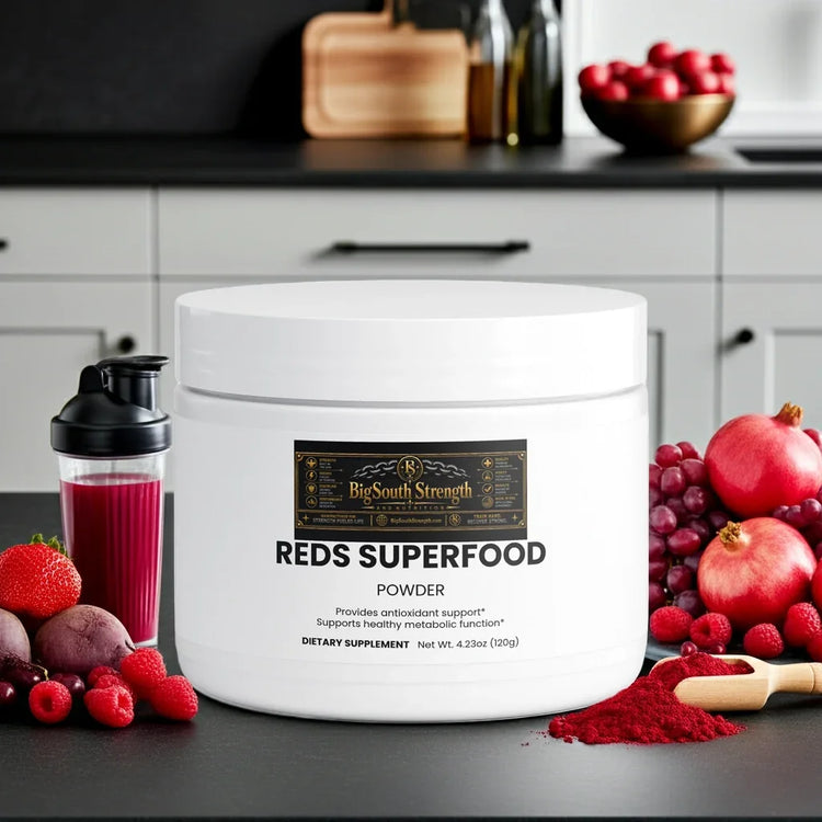 Reds Superfood Powder with antioxidant support, surrounded by fresh berries and pomegranates for wellness.