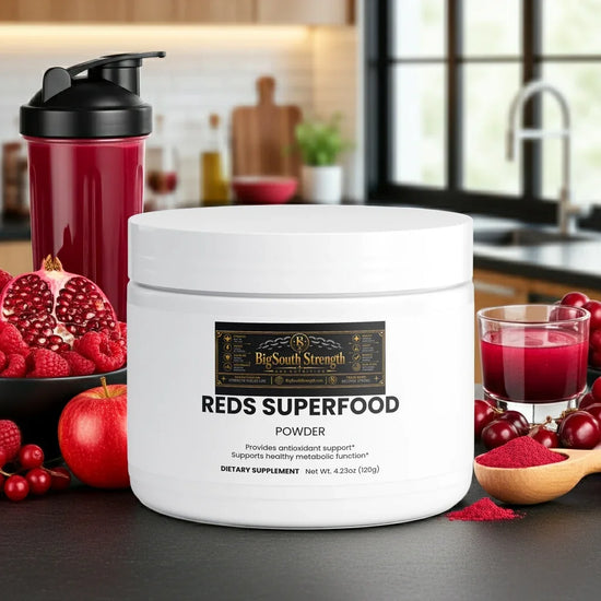 Reds Superfood Powder with antioxidant support, surrounded by fresh berries and a shaker bottle