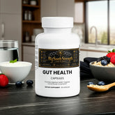 Gut Health Capsules for digestive support, placed on a kitchen counter with berries and yogurt.